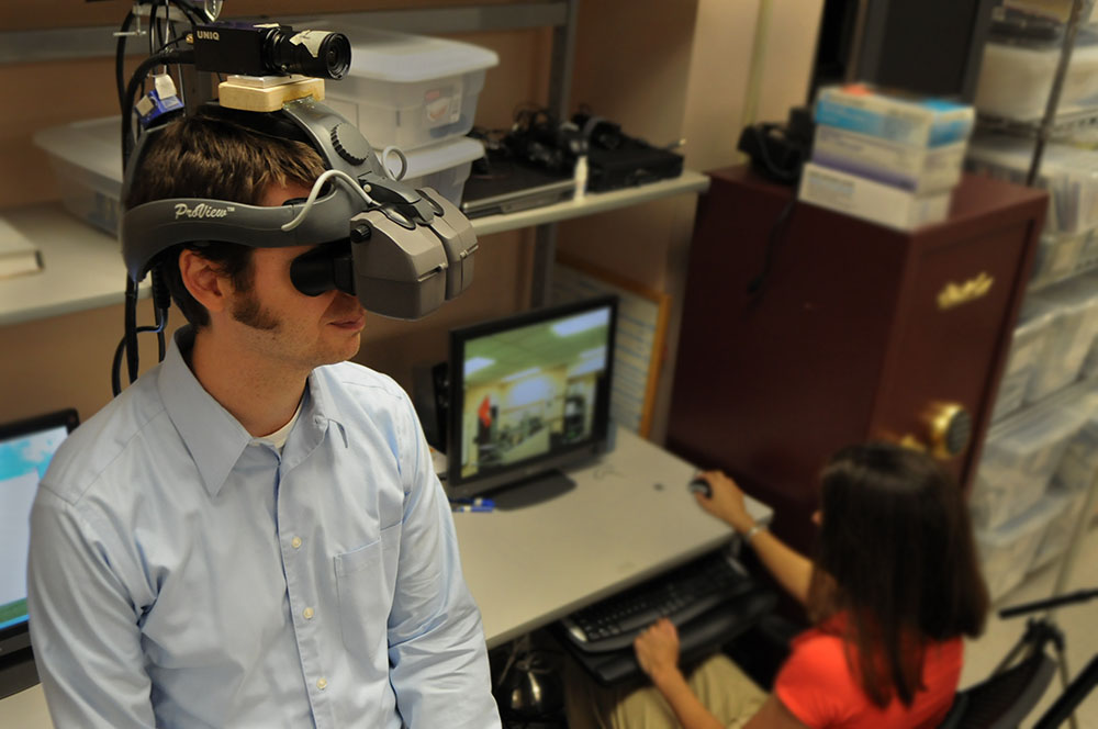 Student wearing a large electronic visual devise on his head