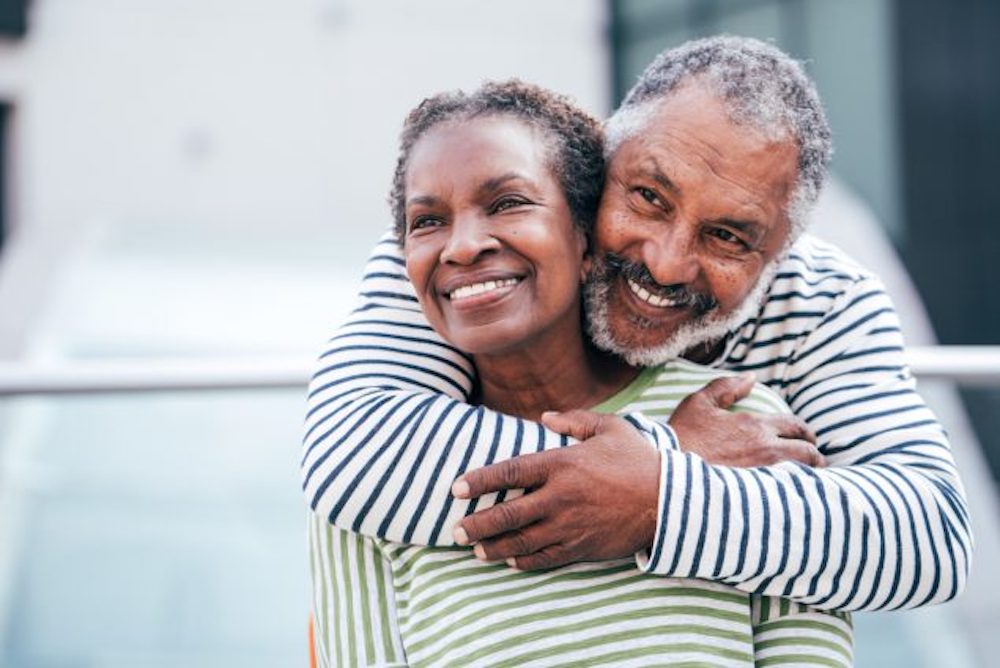 Older man and woman embracing