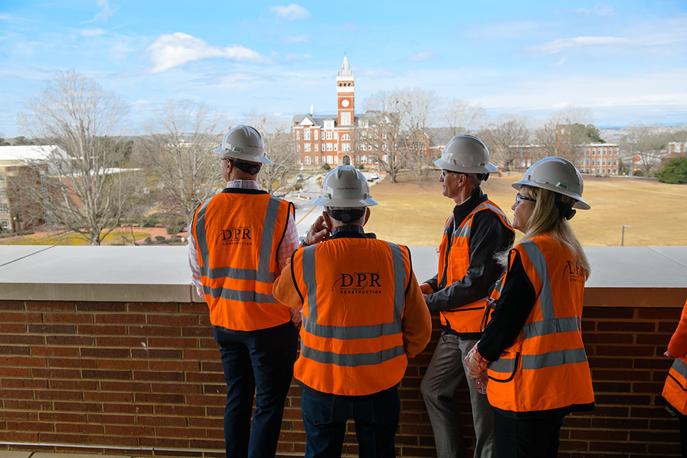 People wearing hardhats speaking