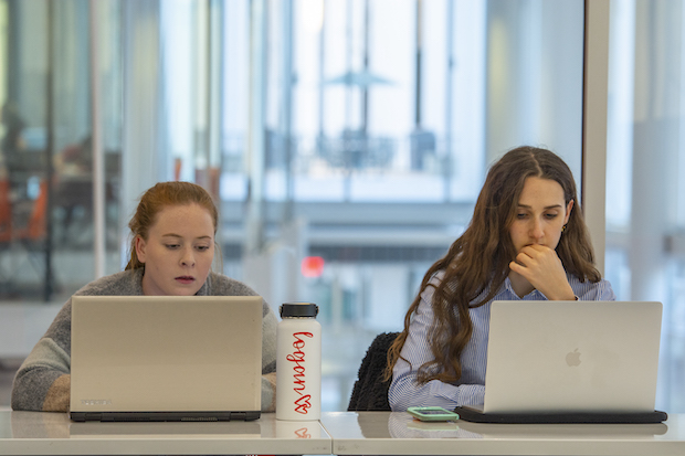 Students looking at laptops