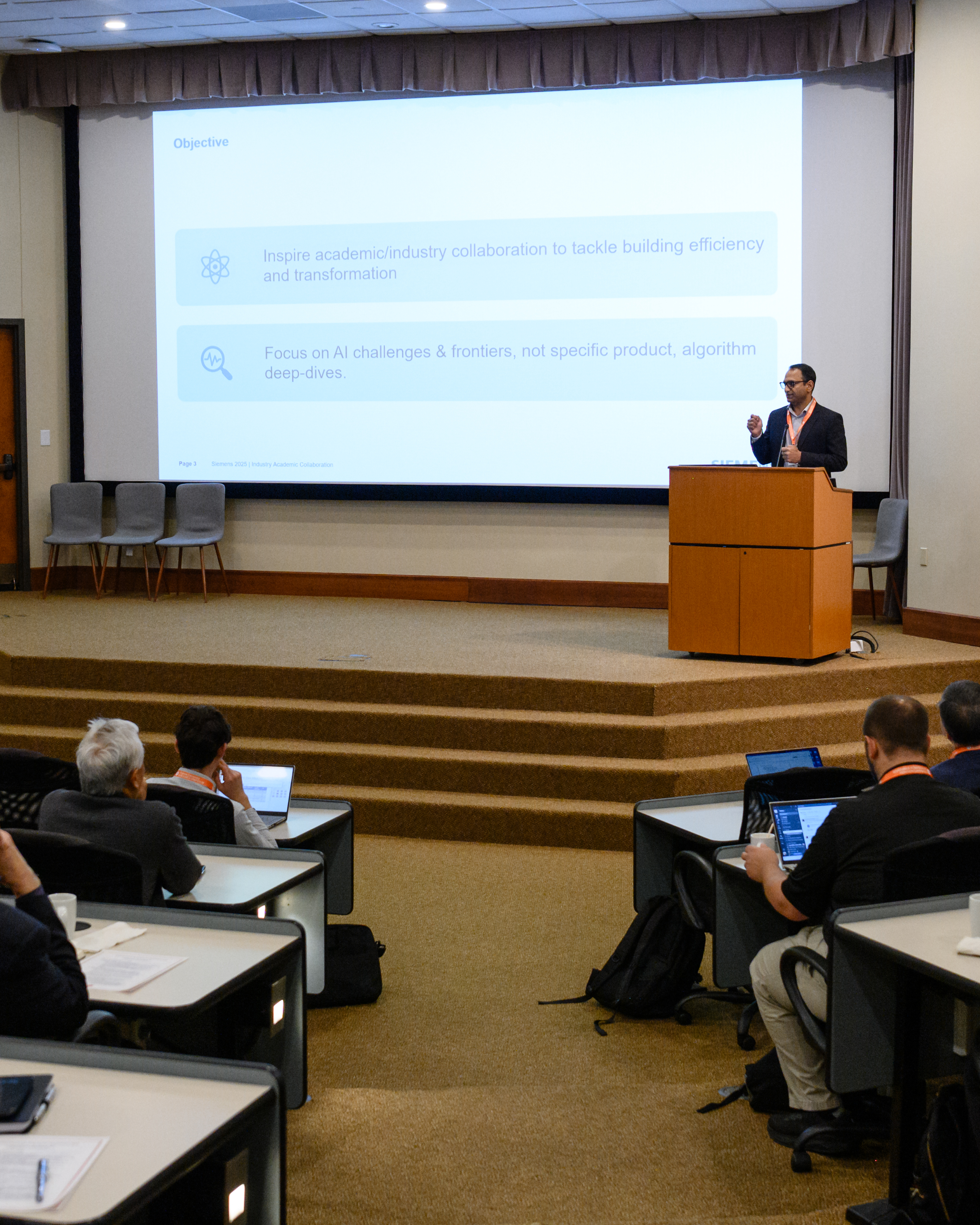 A speaker presenting at the 2025 AI Summit.