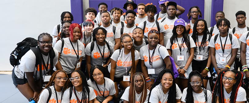 Group photo with several young adults all wearing purple Clemson Emerging Scholars shirts. 