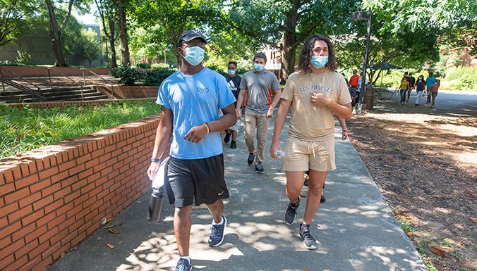 Large group walking on campus.