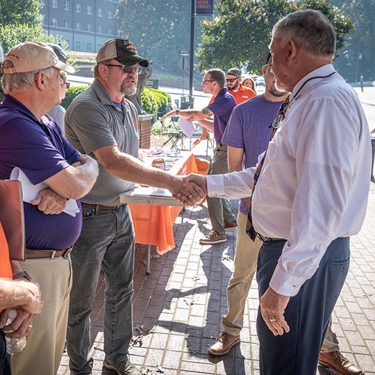 A group of volunteers working a booth on campus