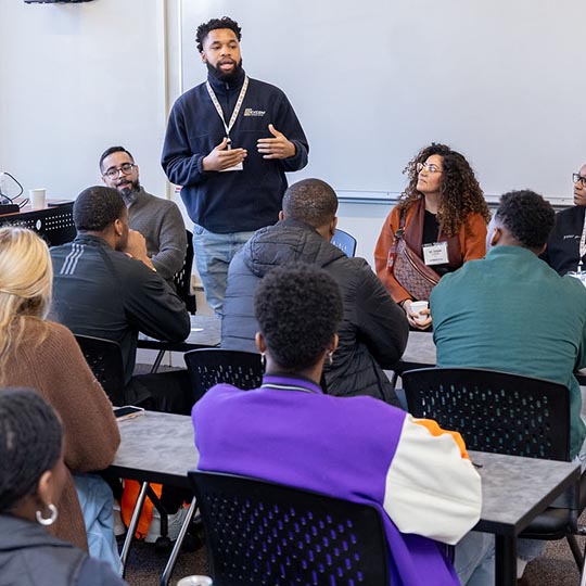 Volunteer addresses a classroom