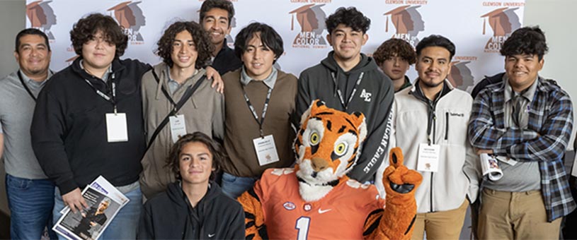 Students at the Men of Color Summit pose with the Clemson Tiger mascot