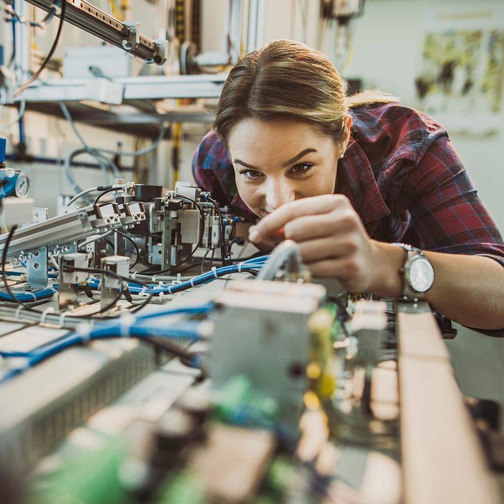 A student works on a piece of lab equipment