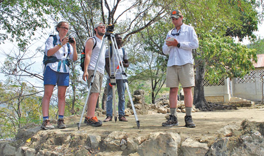 Group surveying on rocky ledge