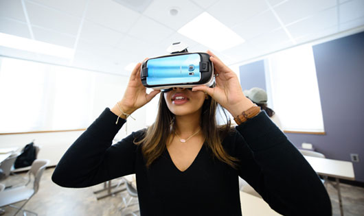 Female using VR headset in class