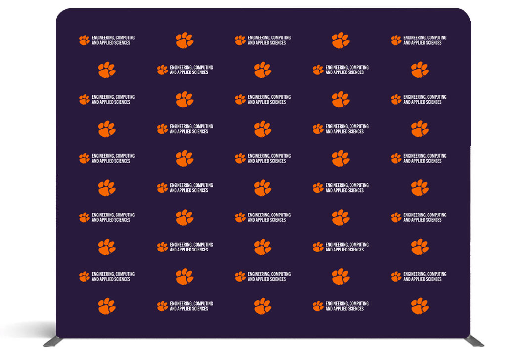 Large backdrop featuring Clemson branding step-and-repeated across a purple background