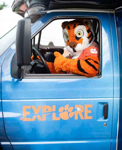 Clemson tiger inside STEM Mobile lab bus with wrapped decal