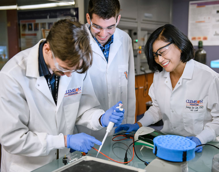 Faculty member in lab with students