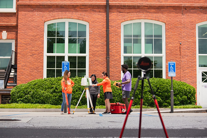 Ogle with students surveying