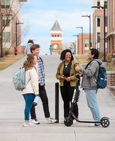 Small group chatting and smiling outside Douthit.