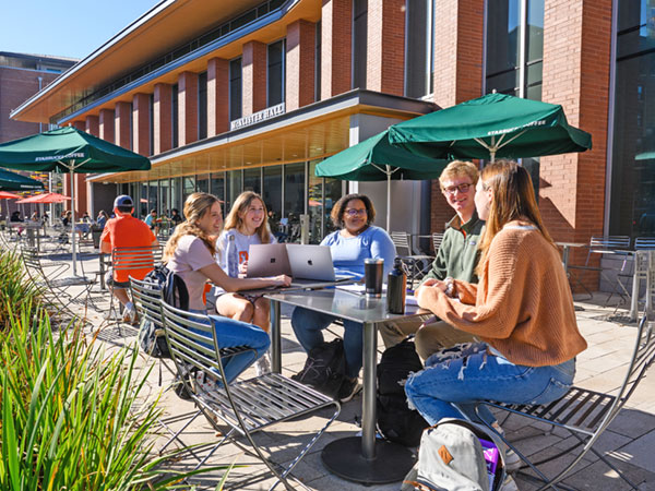 Students at tables outside of McAlister Hall