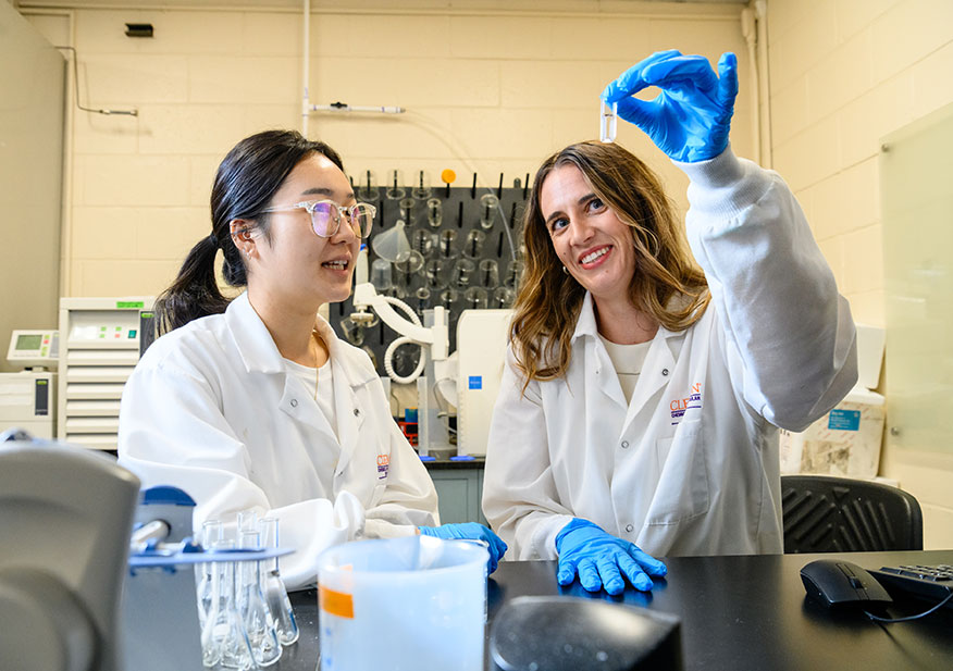 Student in the lab with Professor Larsen, working on NIH grant-funded research.