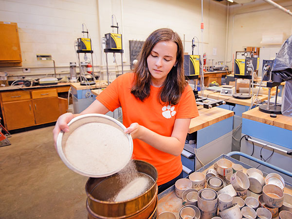 Female student in lab with sediment