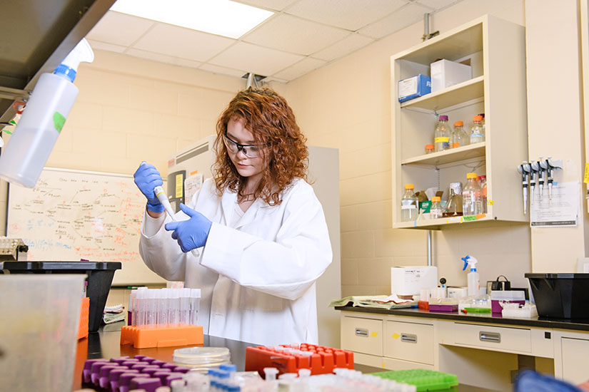 Student in laboratory with vials