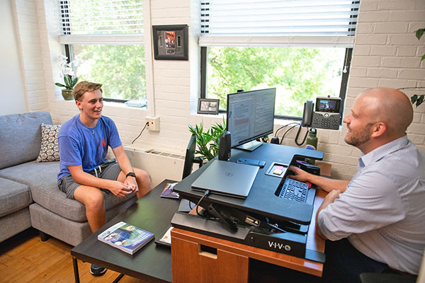 Student and advisor speaking in office