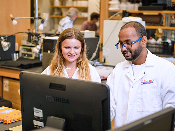 Student and professor at computer