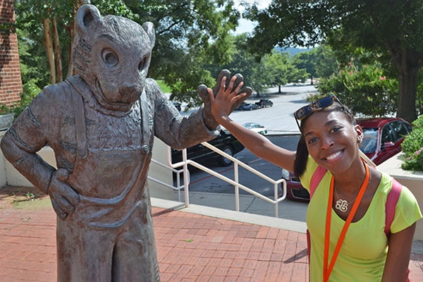 Summer scholar participant with tiger statue