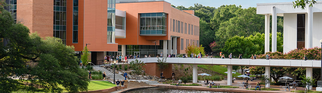 Students walking near Daniel, Cooper, and reflection pond.