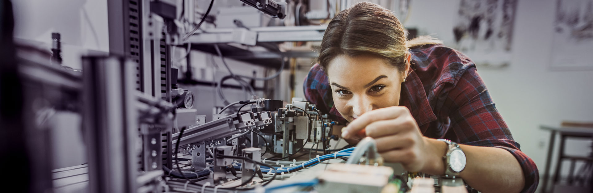 A student works on a piece of lab equipment