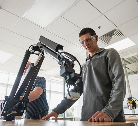 Student and instructor with robot