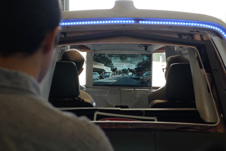 Rear view of interior of vehicle showing drivers display
