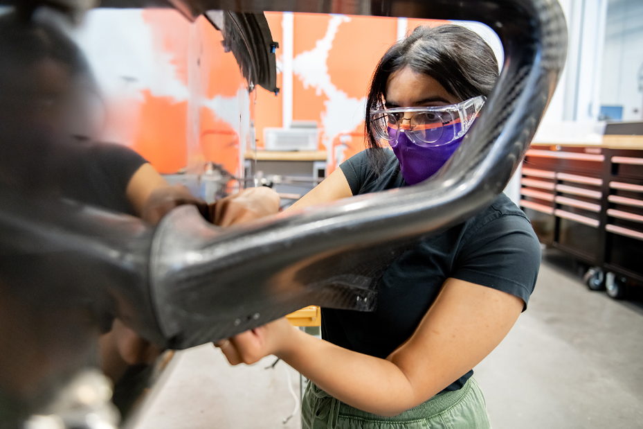 Female student working on DO12 vehicle