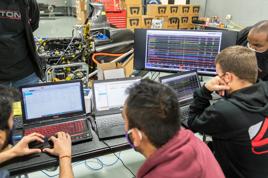 DO12 students examining test data on a computer screen