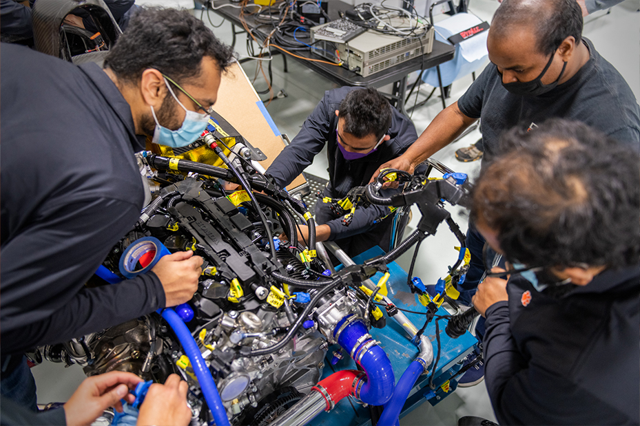 Close-up of several students working on DO12 concept vehicle