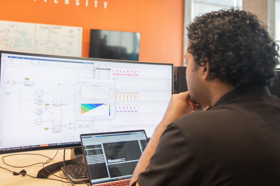 Student inspects simulations on a computer screen
