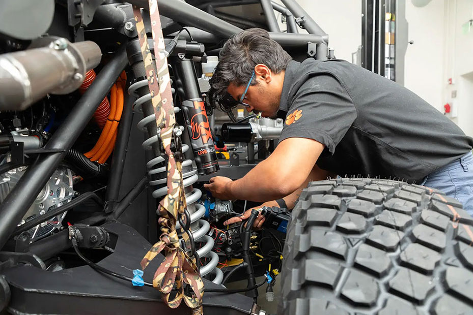 Student inspects suspension system