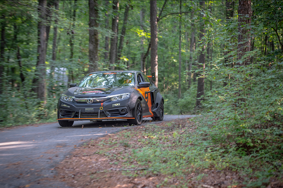 DO9 Vehicle driving down a wooded road