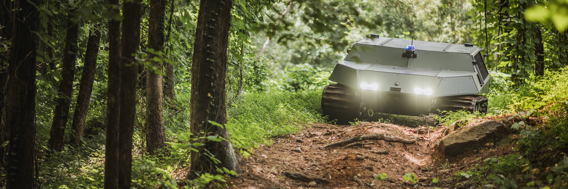 Deep Orange 14 Tracked Vehicle navigating through the woods