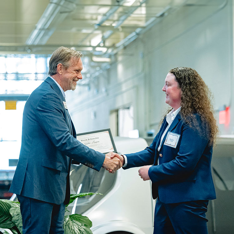 Mears handing an award at ceremony at CUICAR.