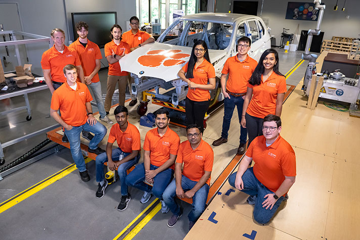 Group of students with car body at CUICAR.