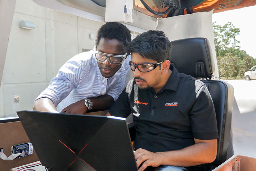 Two students on icar campus using working on Deep Orange.