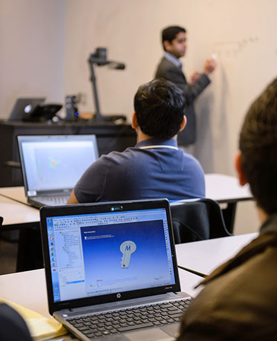 Students in class with laptops.