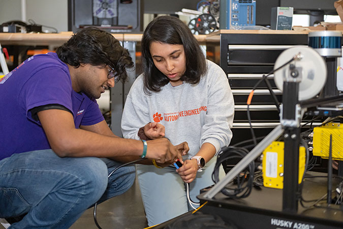 Two graduate students working on autonomous system.