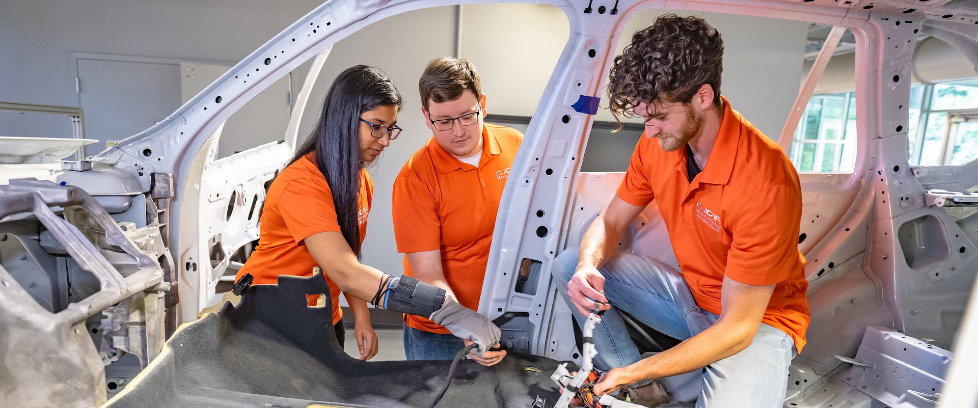 Graduate students at Clemson University ICAR working on car.