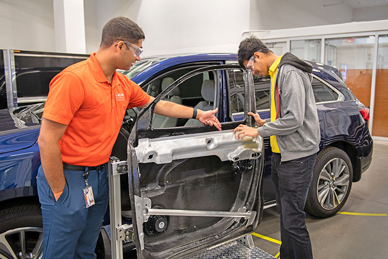 Researchers discussing composite materials.