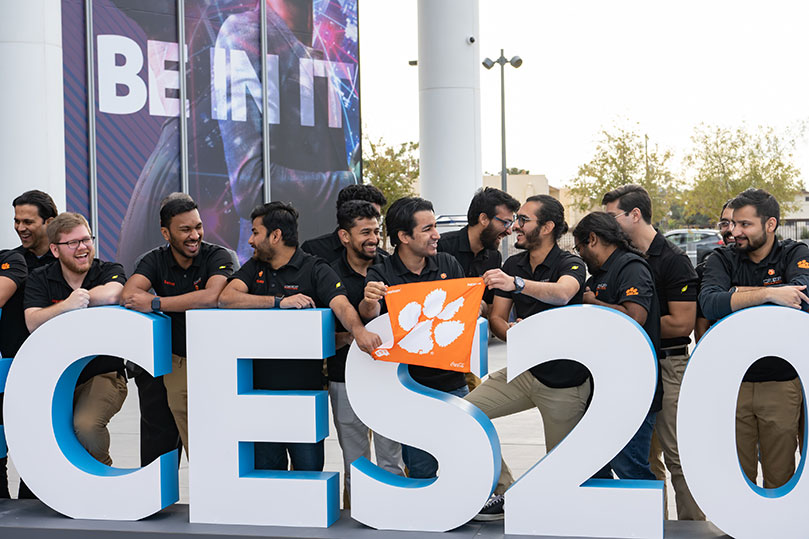 Group that went to the CES event, with orange tiger rag flag.