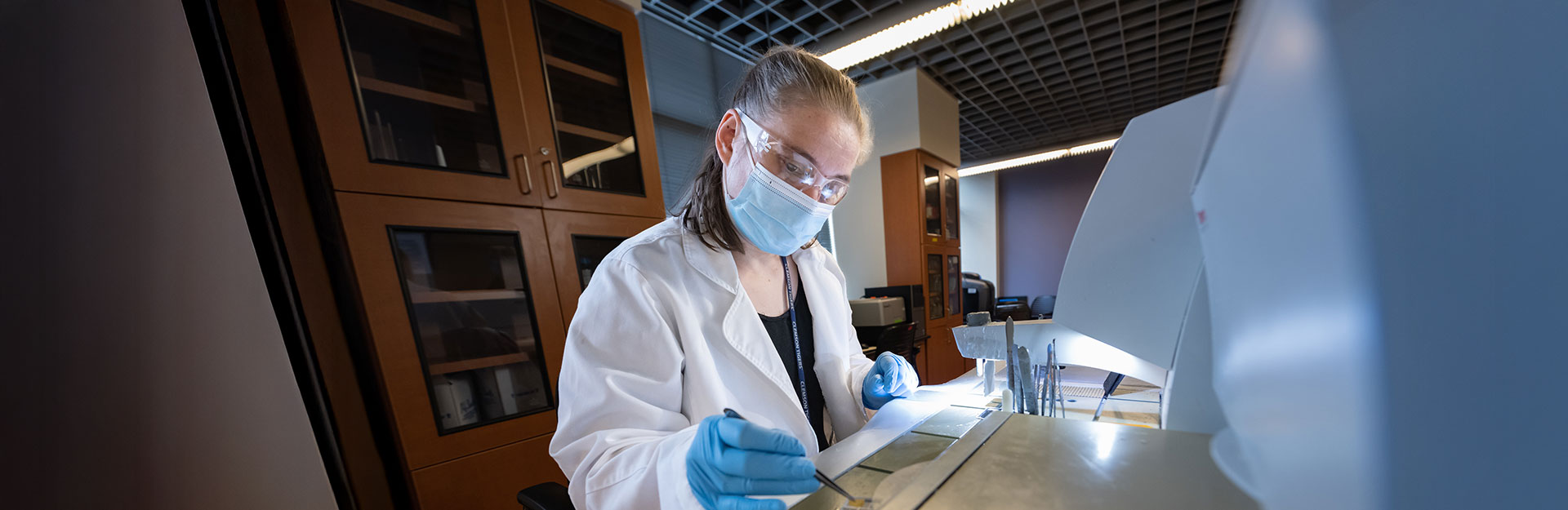 Associate inside lab work station using equipment