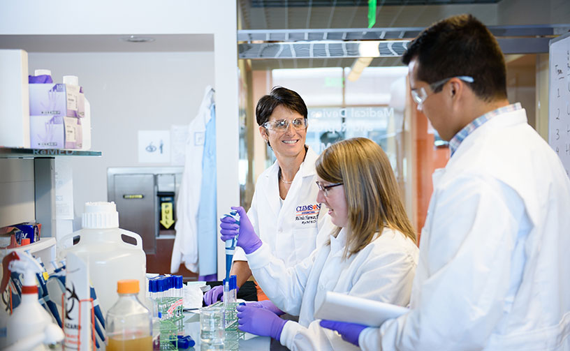 Harman in Re-med lab with two graduate students
