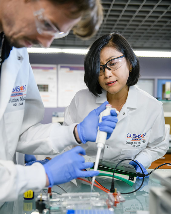 Lee with graduate student in lab