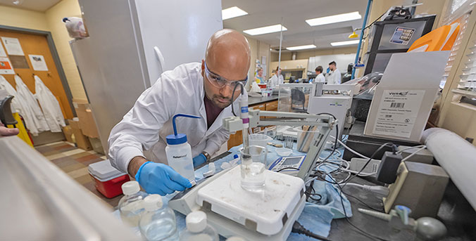 Student in lab measuring substances