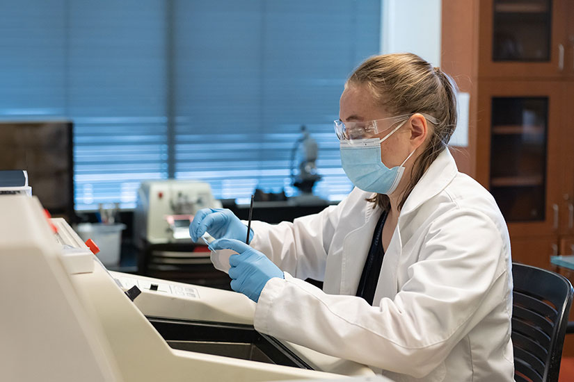 Student in lab using special equipment 