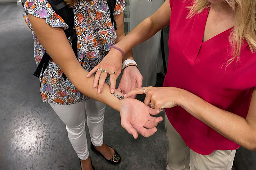 Close up of tiny model placed on wrist of student.